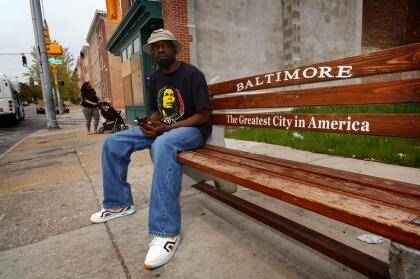James Lewis waits for a bus in the Hollins Market area of Baltimore. Photo: Trevor Collens