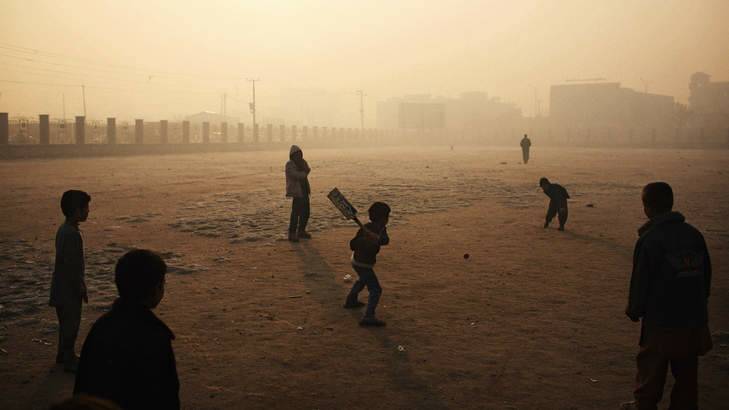 Pitched battle: Boys play cricket on a hazy winter's morning in Kabul. Photo: Andrew Quilty/Oculi