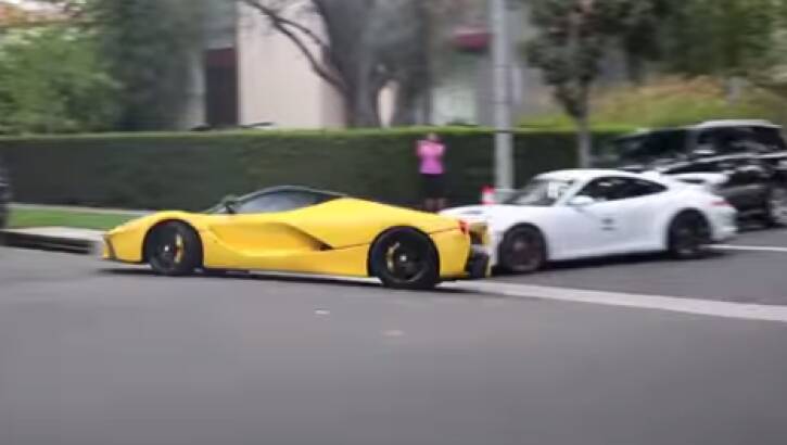 A yellow Ferrari and white Porsche were caught on video drag racing through Beverly Hills, California.  Photo: Youtube