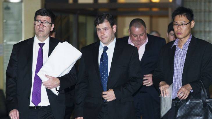 James Ian Longworth, second from left, leaves the Downing Centre District Court. Photo: James Brickwood
