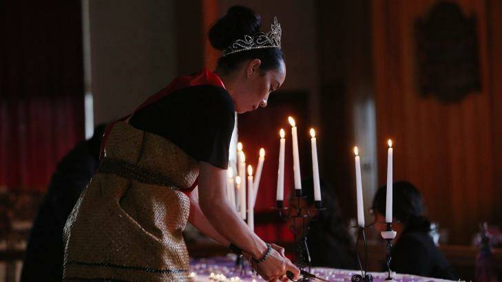 Vigil held: Miss South Auckland lights a candle during a public memorial service for Jonah Lomu. Photo: Hannah Peters