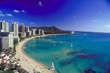Soak up the sun at Waikiki Beach in Hawaii or take a lesson in surfing.