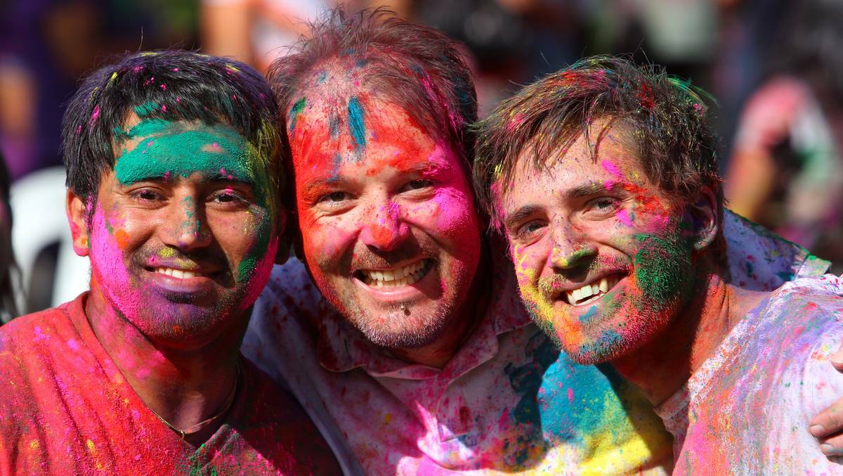 Albury's Harpreet Singh, Tyrone Russell-Smith and Aaron Bykerk take part in the Indian festival of Holi, where coloured powder is thrown over one another. Picture Matthew Smithwick, Border Mail.