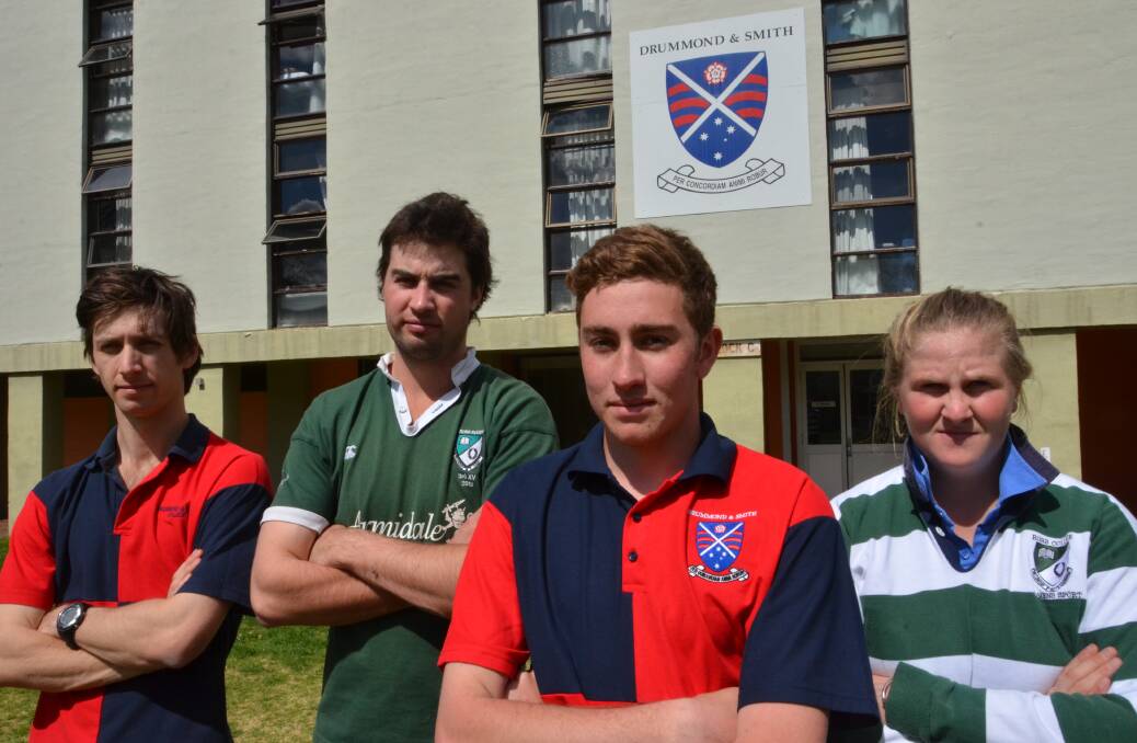 COLLEGE CONFUSION: Adrian Brereton, Doug Cameron, Angus Roby and Emma Bowman stand together in opposition to the university’s earlier decision to combine Robb and Drummond and Smith colleges. Photo: LUCAS FORBES.