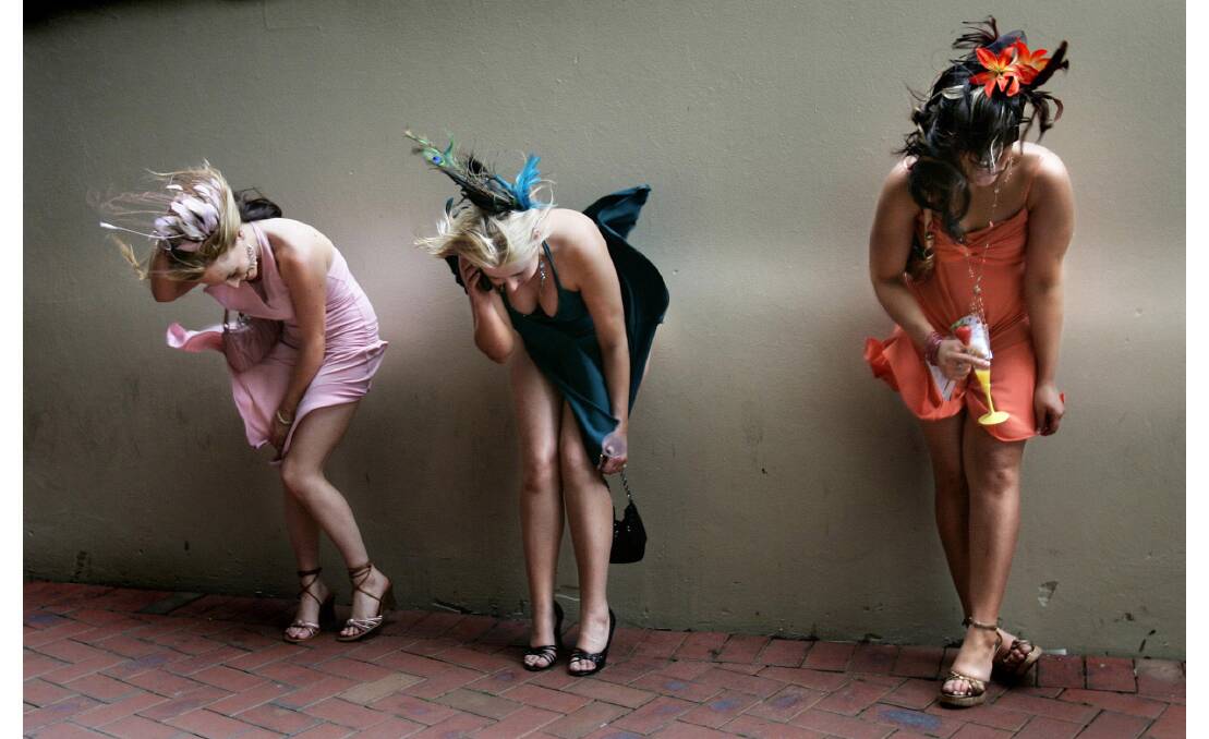 These girls managed to keep their headgear in place despite the wind at Oaks Day 2005.  PHOTO: Fairfax Digital Collection.