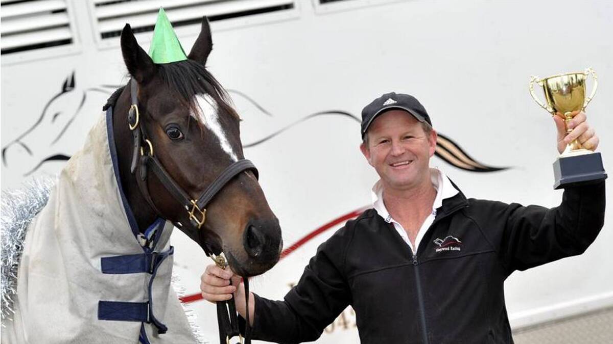 CELEBRATING: Wagga trainer Chris Heywood celebrates his first Southern District Racing Association trainers title with Leucura. Photo: Les Smith.