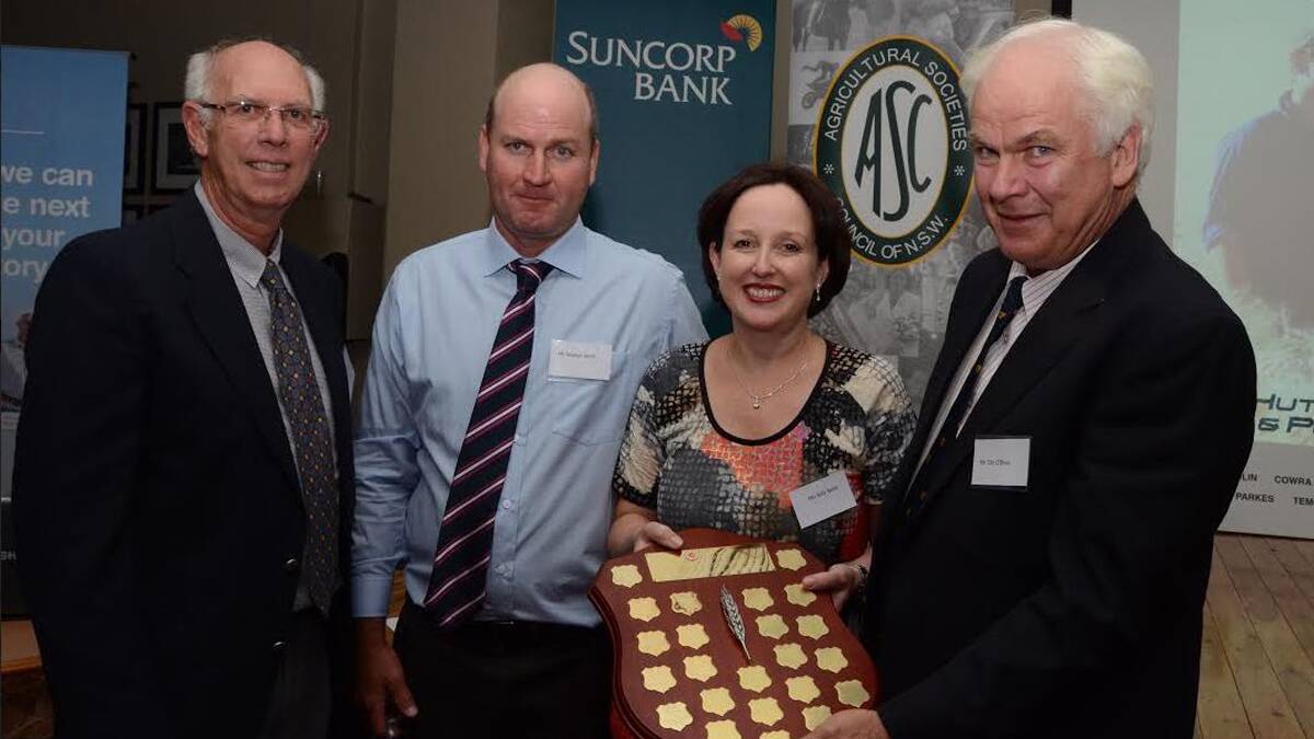 EXCELLENCE REAWRDED: Stephen and Sally Smith (centre) are presented with their Excellence in Farming Award. Also pictured are NSW state finals judge and Agricultural Societies Council of NSW chairman Tim O’Brien.                                             Photo: Mark Griggs, The Land Newspaper