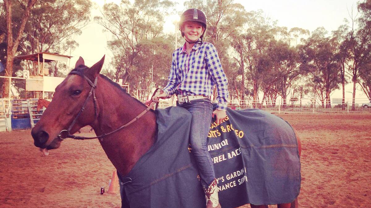 STAR: St Mary’s Primary School student Faith James and her horse Charlie wearing the rug they won for their efforts in the barrel racing at West Wyalong on Sunday. 		  			  (sub)