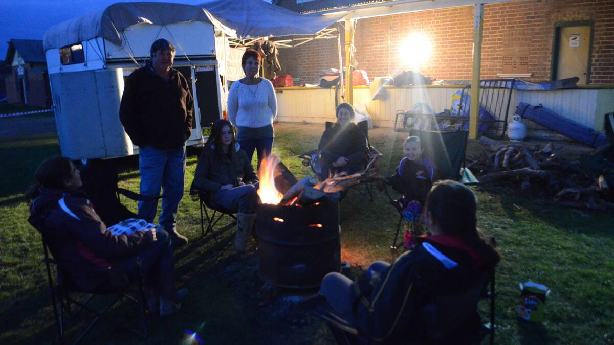 CAMP: Jean Egan, Charlotte, Adele and Warwick Miller, Kayleen Law and Tara Millard of Ulladulla kept warm in their camp around a makeshift fire at the Young Showground on Wednesday night.     (ponycamp (3))