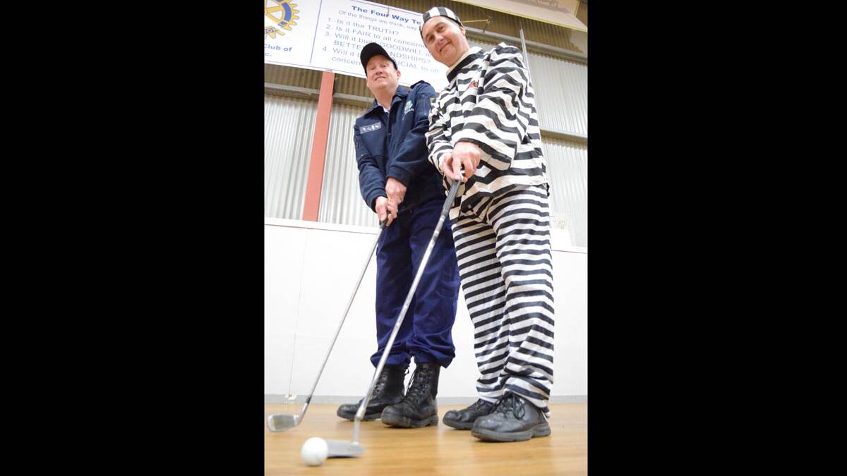 HIT IT: Senior Constable Brendan Clark and Young PCYC manager Martin Langfield are all lined up for the Time 4 Kids fundraiser and golf day which will see funds go towards the construction of a new dance and martial arts room.                  (time4kids4)