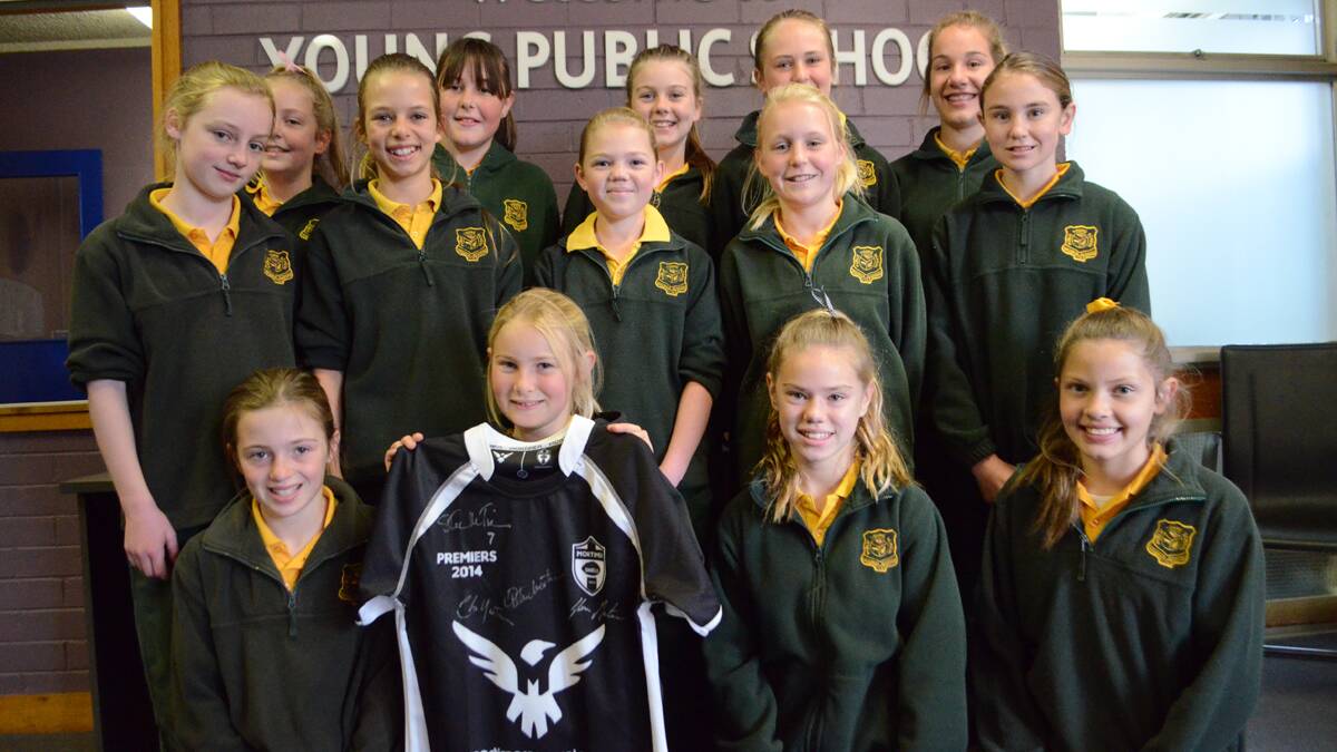 TOP JOB: The Young Public School Year 5/6 league tag team pictured with a Mortimer Shield jersey. Back, left to right: Abbey Debusch, Tahlia Scott-Miller, Tahlia Hoskins, Abby Lucas and TJ DalMolin. Middle, left to right: Jayda Hall, Tessa Watson, Michaela Summerfield, Sophie Davidson and Marnie Schiller. Front, left to right: Ellie Croker, Tanna Roberts, Darcy Sing and Georgina Everdell. Absent: Aerial Pettit, Alyssa Wonson and Emily Hills. 	         (YPSleaguetag 002)