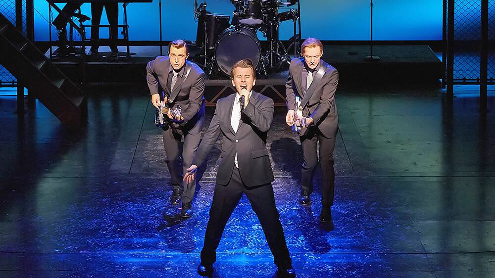 CENTRE STAGE: Matt Hunt (left) showing off his guitar skills as he performs in Jersey Boys at the Prince Edward Theatre in London.  
Photo: BRINKHOFF/MOGENBURG