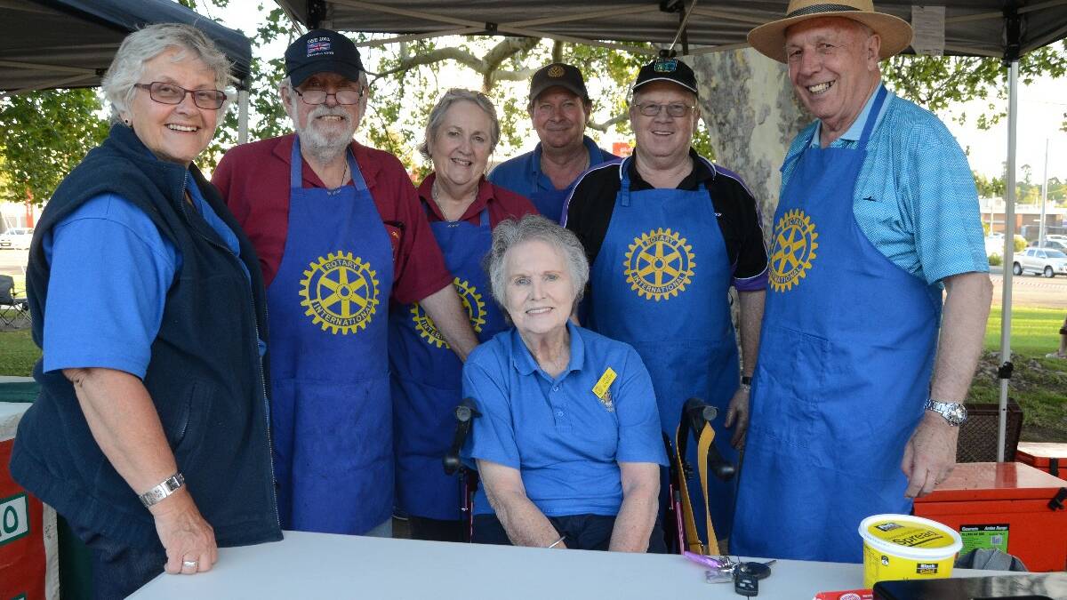 Jan Martin, Graham and Margaret Fathers, Paul Sheather, Ted Loader, Cliff Sheridan and Rotary president Irene Dowsett (seated) at their stall.