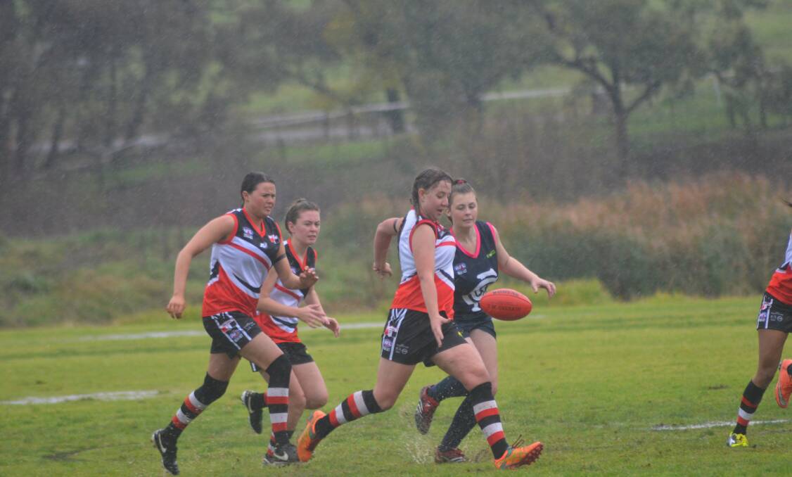 RIGHT: Young Saintee Maddi Parr in action in most unpleasant conditions on Saturday. 