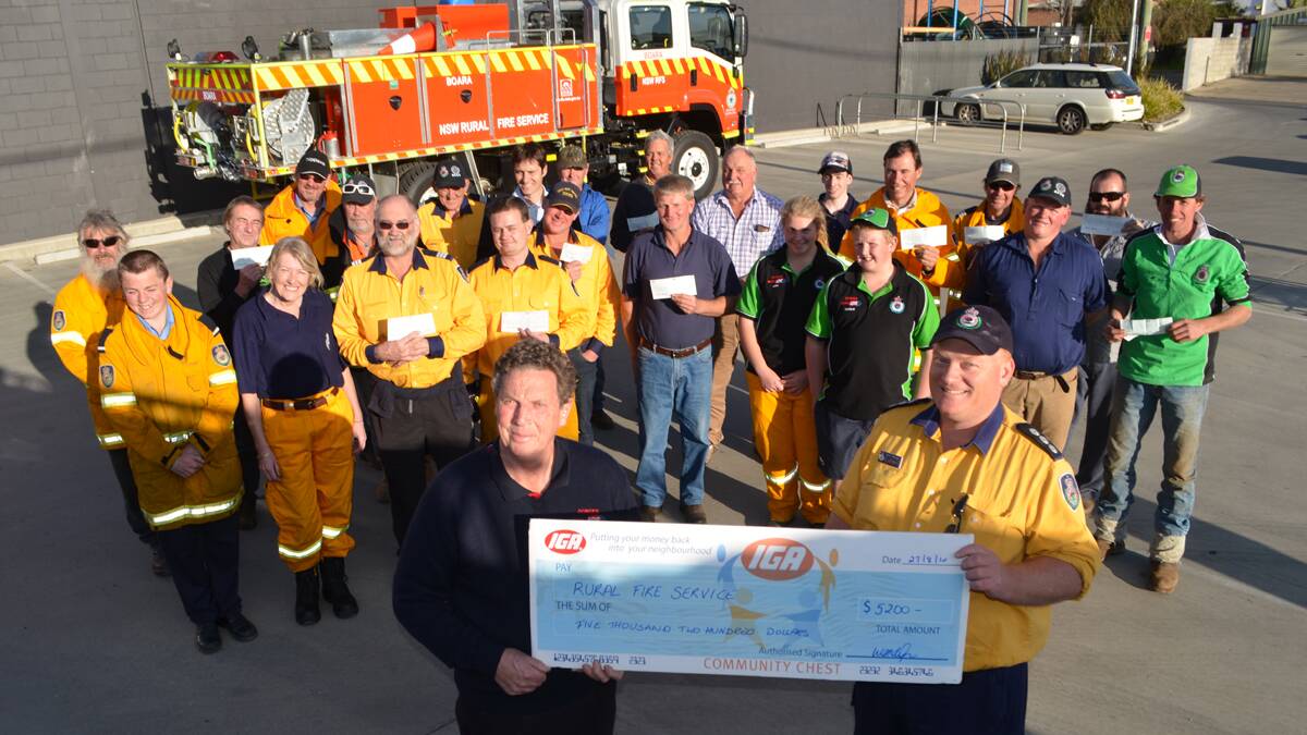 PRESENTATION: Donges Supa IGA owner Robert Donges presents RFS South West Slopes Zone representative David Nicholson, every RFS brigade in Young and cadets with their cheques. 	  	          (rfscheqs 026)