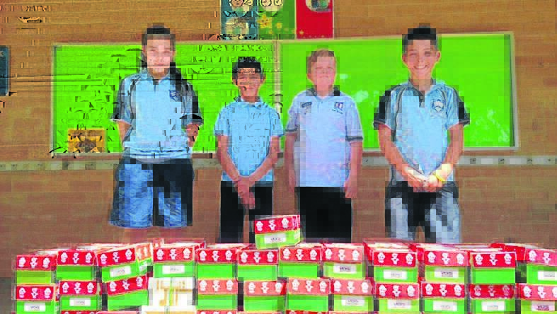 WRAPPED UP: Students from the leadership team heave a sigh of relief after packing 52 boxes for Operation Christmas Child at Young North recently. Pictured are Imogen Robinson, Isaac Arja, Seth Schulz and Tristan Perceval.                                                                                                       (sub)
