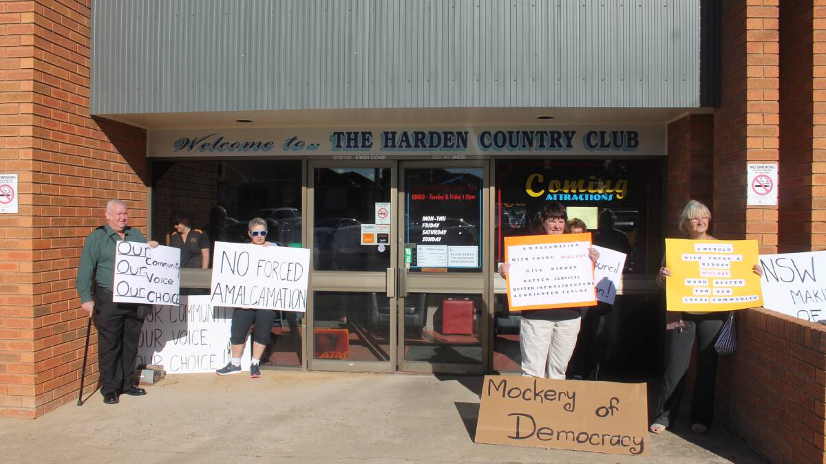 MERGERS: Harden residents brandishing placards outside the Harden Country Club on Friday morning, making their feelings clear during the merger inquiry. 