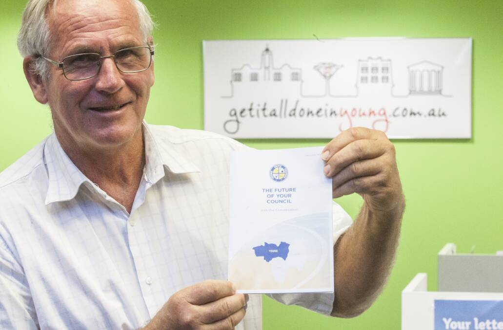 ayor John Walker with the pamphlet which will be distributed to local households outlining the merger proposition and the options up for consideration. 	