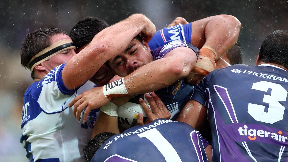 Young Tonumaipea of the Storm is tackled by Josh Jackson and Tim Lafai . Picture: Getty