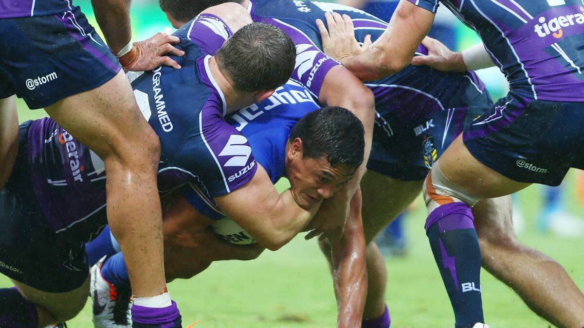 Chase Stanley of the Bulldogs is tackled by the Storm defence during the round four NRL match between the Canterbury-Bankstown Bulldogs and the Melbourne Storm. Picture: Getty