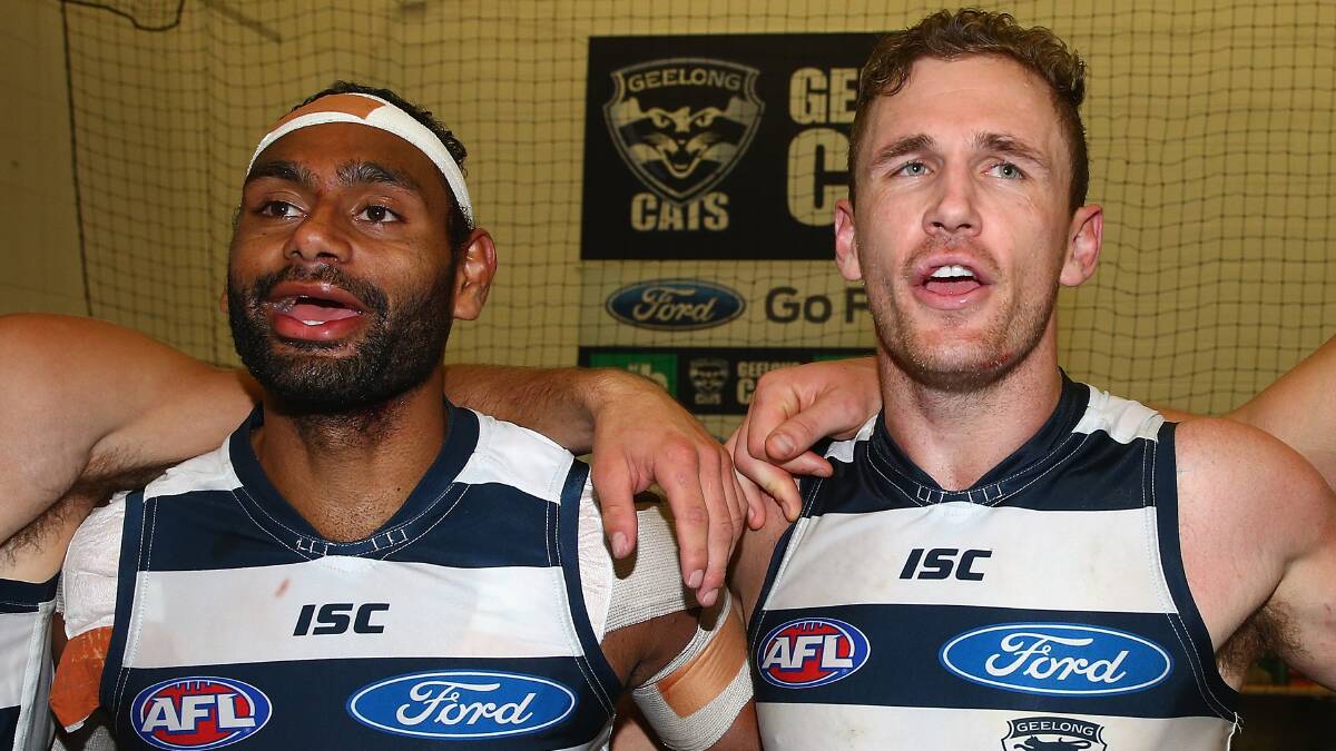Travis Varcoe and Joel Selwood of the Cats sing the song in the rooms after winning the round three AFL match at the MCG. Geelong ran out 87 points to Collingwood's 76. Picture: Getty Images