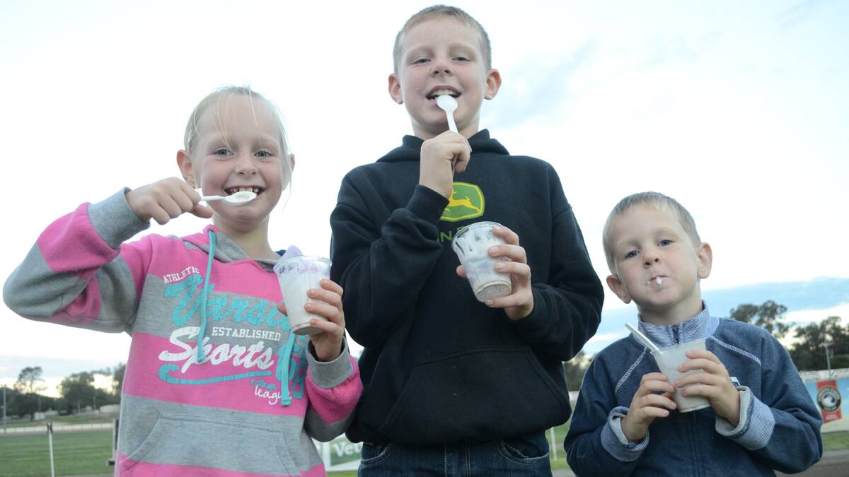 YUM! The ice-cream truck and jumping castle certainly kept these youngsters entertained. Pictured are Caitlin (6), Blake (9) and Dylan (4) Thompson.  