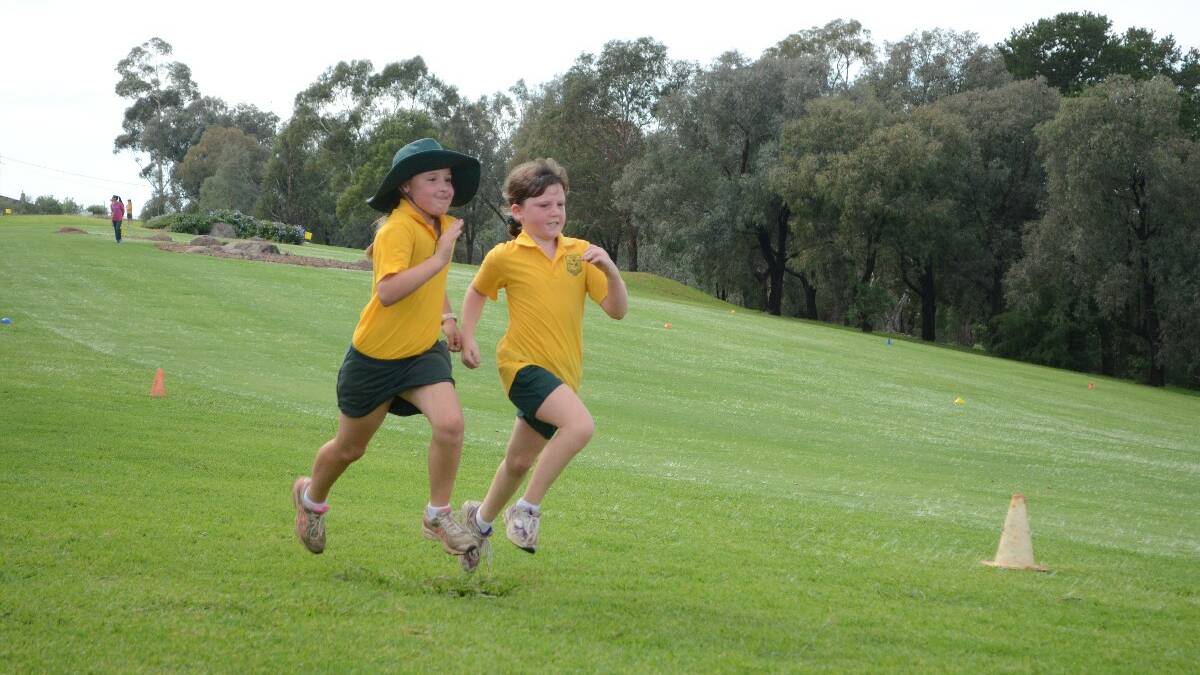 RACE: Year 3 Young Public School students Ella King and Mikayla Spring raced to the finish line. 