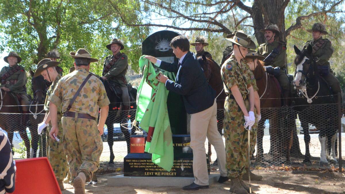 CEREMONY: Member for Hume Angus Taylor unveils the cenotaph at Murringo last weekend.