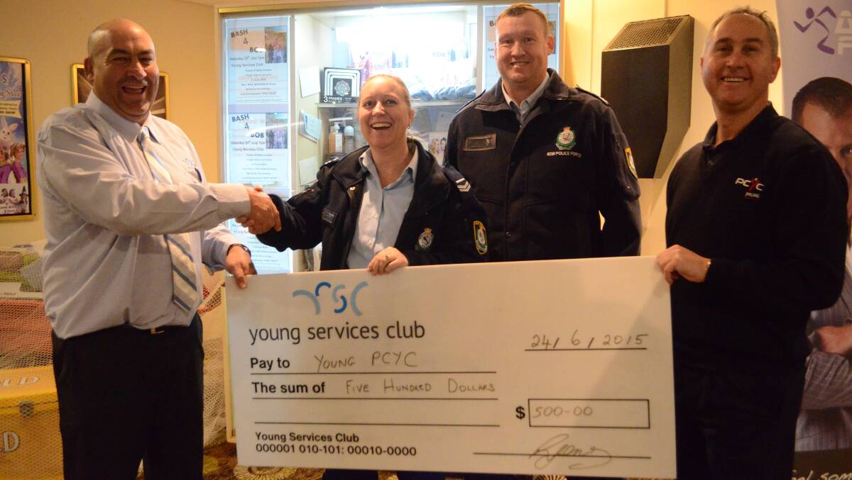 DONATION: Young Services Club manager Brad Pettit presented a $500 cheque to youth case managers Senior Constable Karen Clark and Senior Constable Brendan Clark, and Young PCYC manager Martin Langfield.      