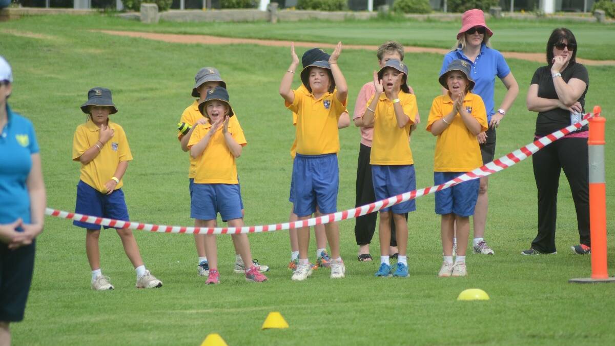 SPIRIT: St Mary’s students cheering on their schoool mates as they cross the finish line.  