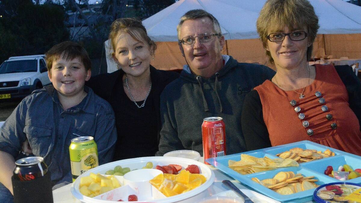 DINING OUT! Kayleb Dalton (10), Michele Doherty, Wayne Long and Tanya Miller, all of Young set themselves up nicely with snacks and drinks at the Young Carnival of Cups.