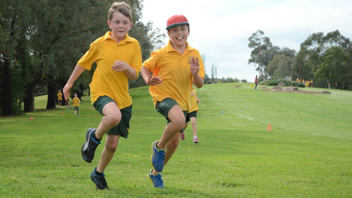 FUN: Year 4 students Jacob Maslin and Adrian Waru were in good company when they raced for the finish line. 	