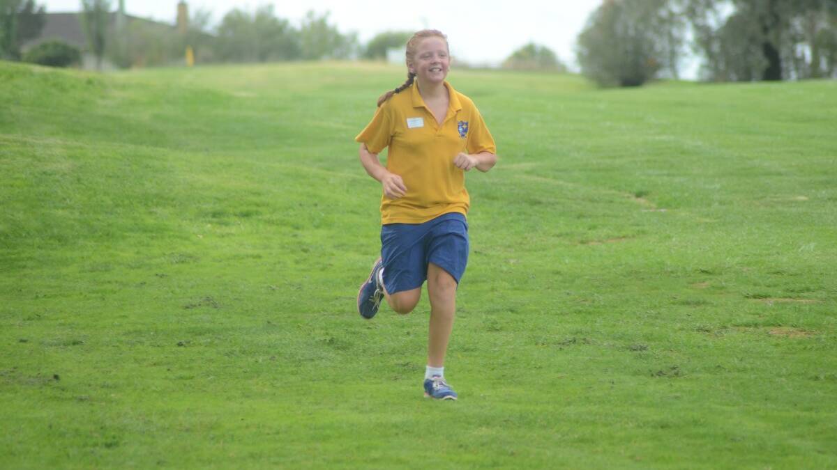 FUN: Skye Smith from St Mary's Primary School was all smiles as she approached the finish line.	