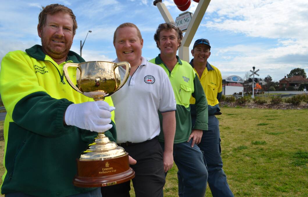 SURPRISE! Some Young locals, including tourism manager David Newberry (centre) with the Melbourne Cup last year when it made an unexpected stop in the Cherry Capital.