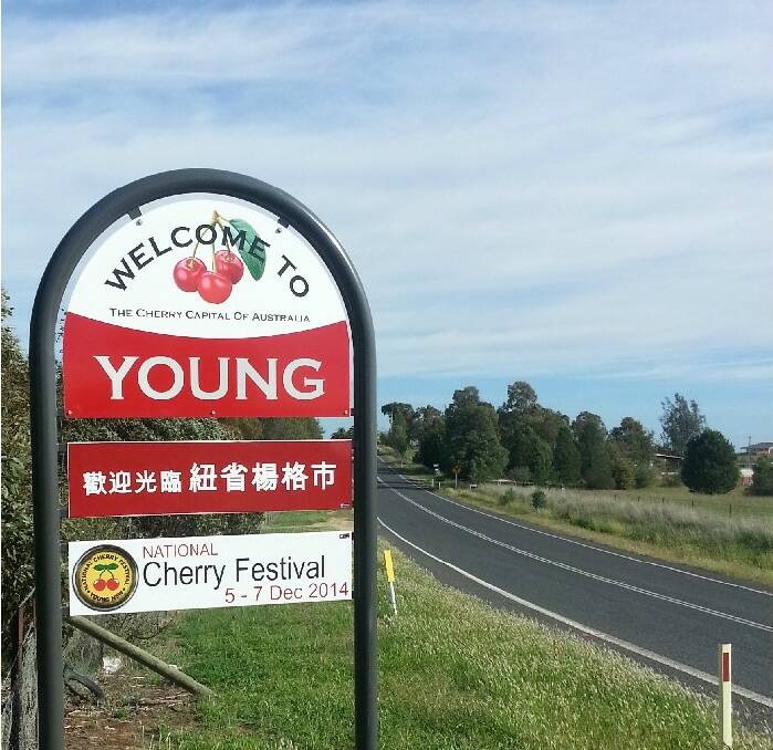 Town signs confer a Chinese welcome: Welcome signs positioned on major roads into Young went bilingual for the Lambing Flat Chinese Festival with the addition of a new panel written in Chinese.