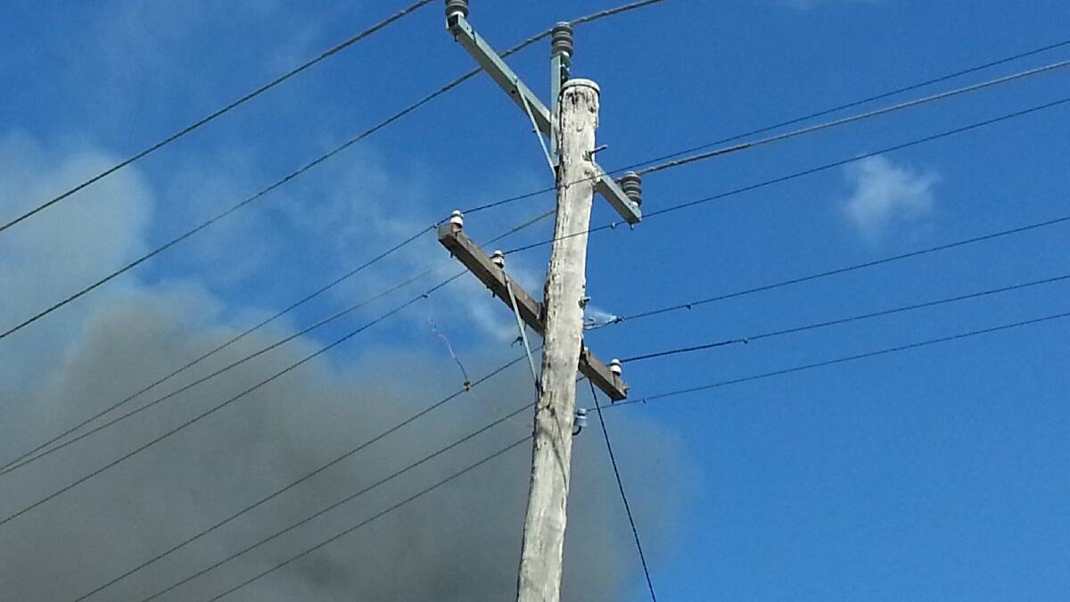 The power lines across the road from the Boorowa Street house that was engulfed in flames began smoking.