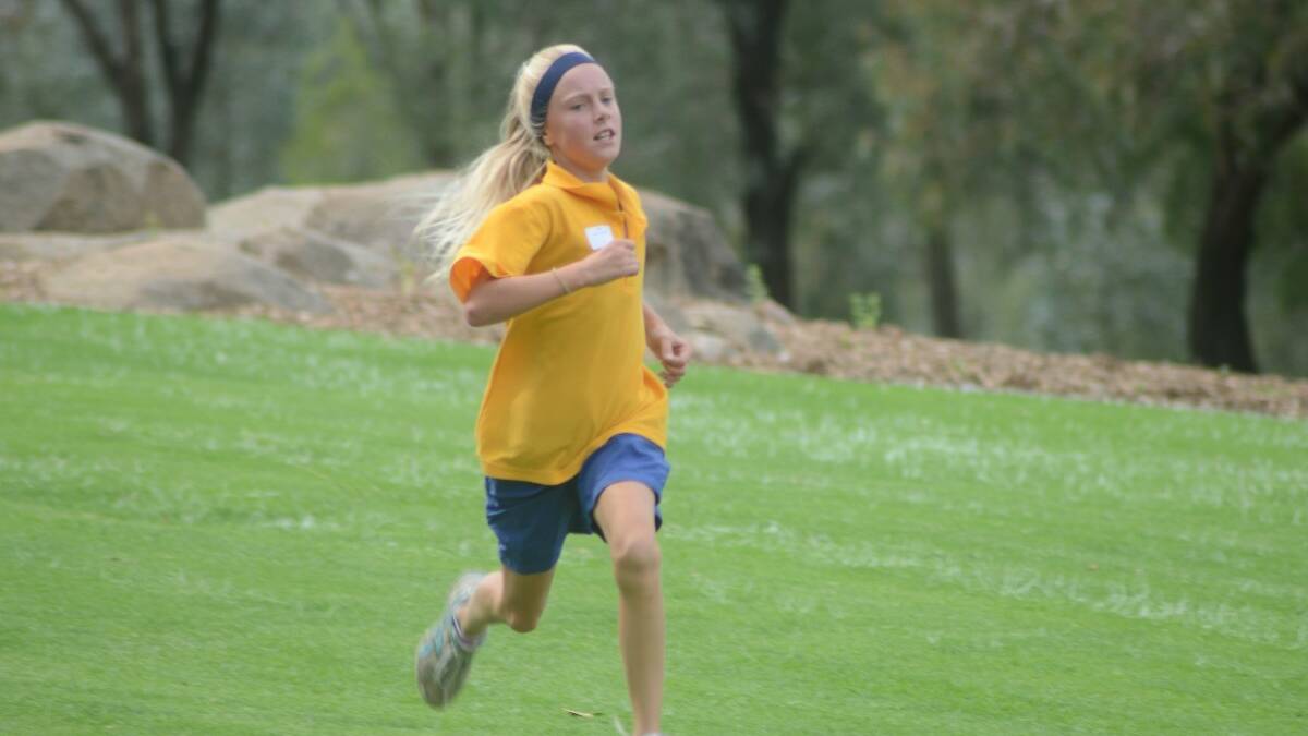 RUN: Grace Connelly approaches the finish line during St Mary’s cross country event recently. 	