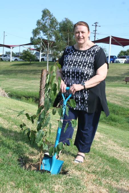 TREE PLANTING: Young’s Australia Day ambassador Valerie Parv planting a tree along the banks of Burrangong Creek. 