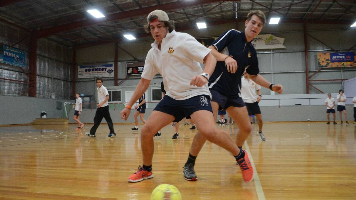 GALA DAY: Young High School student Joel McKenzie puts the pressure on Cootamundra High School student Caleb McNally during the Youth Gala Day on Friday. 