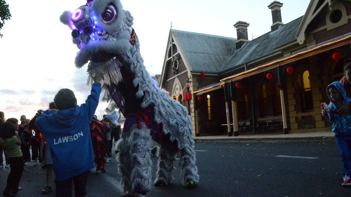 INTRIGUED: Children took particular delight in the lion dancers who frolicked around them after their performance in Anderson Park.