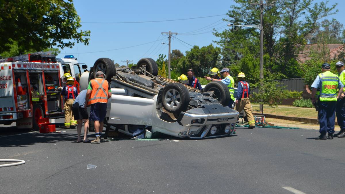 A 51-year-old woman had to be freed from her overturned car when a driver failed to give way to her on Wombat Street just after midday yesterday.