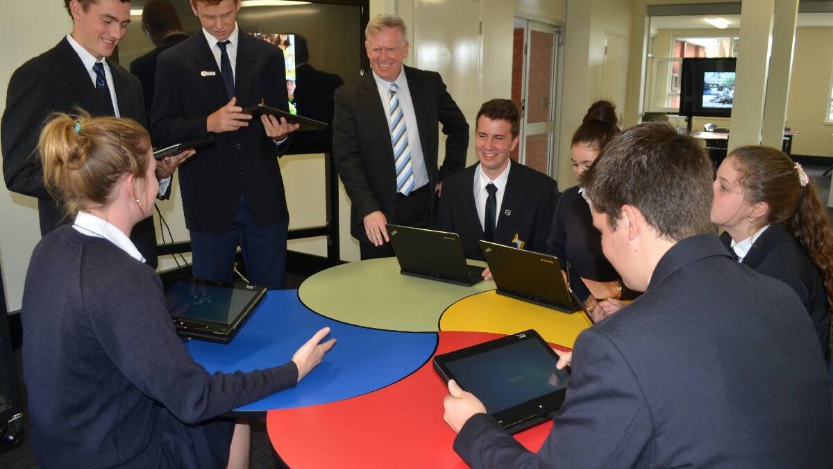 Hennessy Catholic College principal Dr Peter Webster lets students (from left to right) Lauren Jenkins, Michael Livolsi, Mitchell Trinder, Jake Cummins, Isabella Foreman, Georgie Butt and Cameron Livolsi, take the new high-tech centre for a test run.