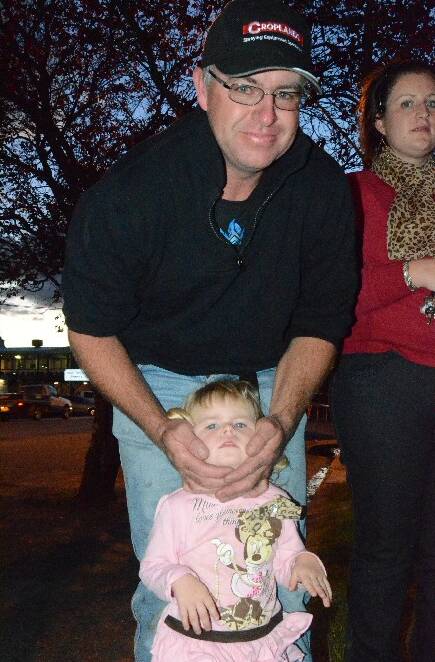 NOISY: The Chinese fireworks were too noisy for Alana Shean as dad Tim covers her ears.