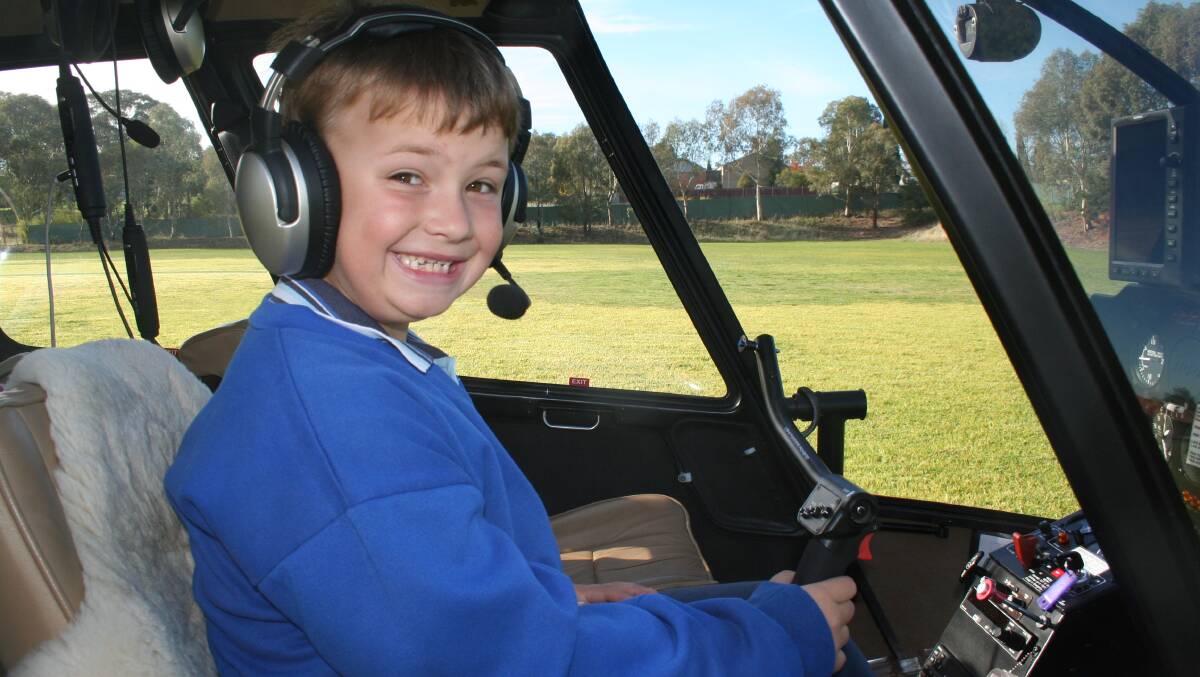 EARLY BIRTHDAY PRESENT: A pretty excited Cooper Wrona prepares for take-off in the helicopter on Monday morning. 