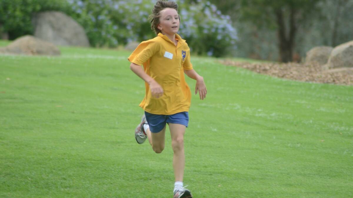 FIRST PLACE: A very happy Liam Stuart, from St Mary’s Primary, was proud to be the first boy in the 11 years to cross the line.
