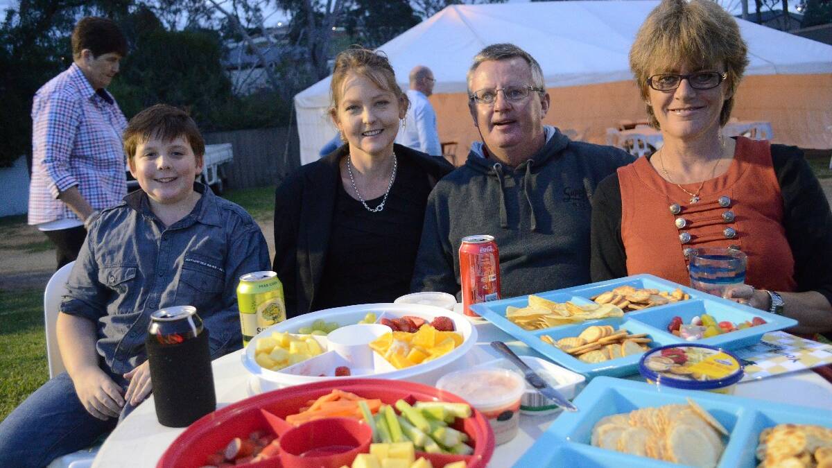 DINING OUT! Kayleb Dalton (10), Michele Doherty, Wayne Long and Tanya Miller, all of Young set themselves up nicely with snacks and drinks at the Young Carnival of Cups.