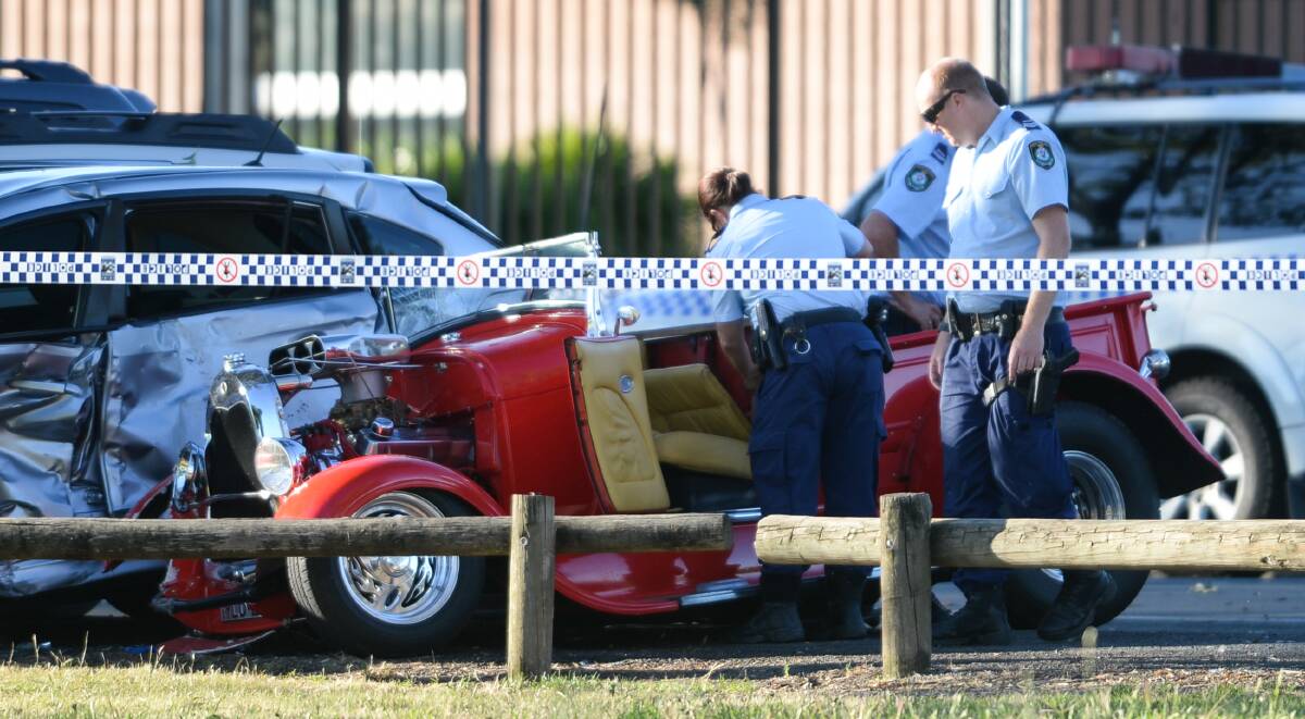 DAMAGED: Police examine the hot rod after it crashed on Douglas Road in Lavington on Sunday afternoon. Picture: MARK JESSER