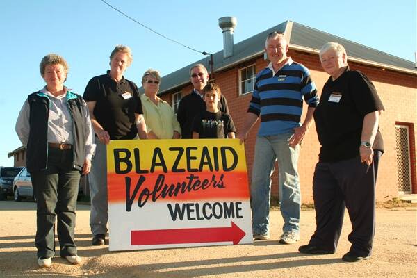 WELCOME: Helen Sell, Jan Gursanscky, Pat Potbury, Zac Sell, Young’s mayor Stuart Freudenstein, David Tame and Cheryl YouKee were at Young Showground on Friday to start setting up the volunteer camp.