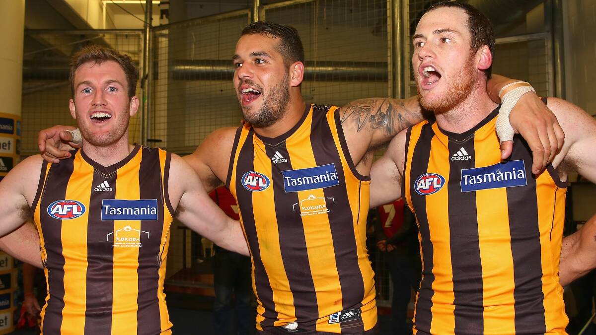 Xavier Ellis, Lance Franklin and Jarryd Roughead from Hawthorn sing the song in the rooms after defeating the Eagles Photo: Getty Images.