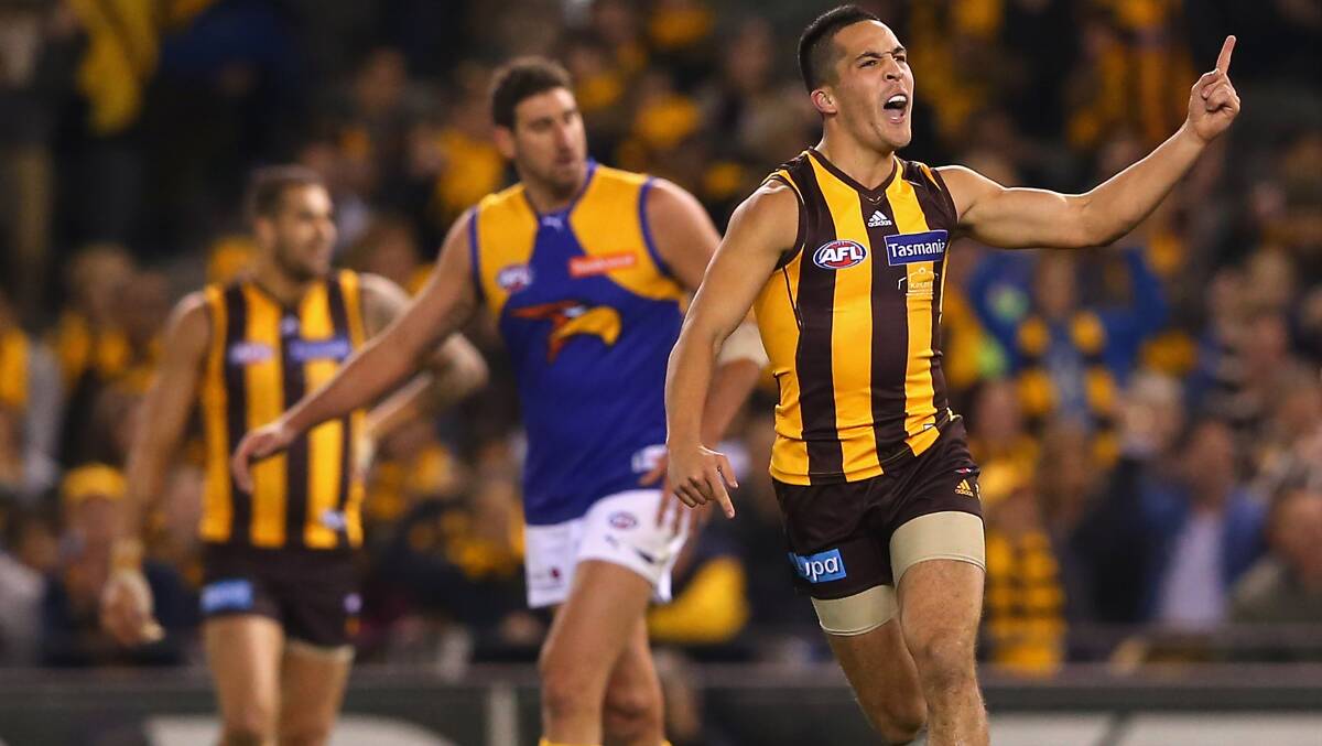 Shane Savage of the Hawks celebrates kicking a goal for Hawthorn. Photo: Getty Images.